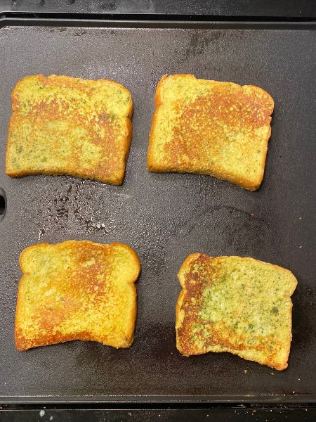 flipped matcha french toast cooking on a griddle