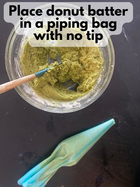 matcha donut batter in a piping bag