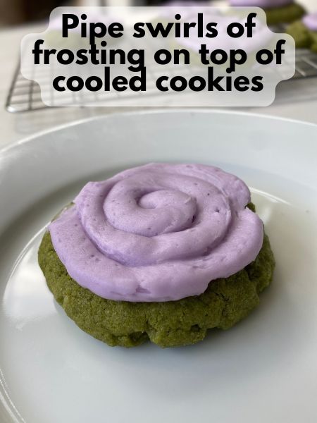 lavender frosting piped on top of matcha sugar cookie in a swirl