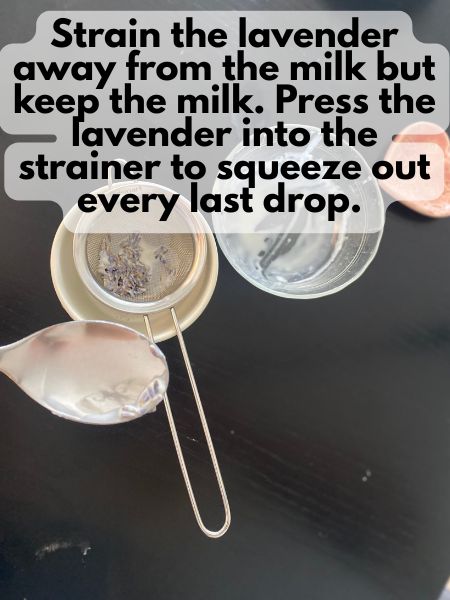 strainer straining lavender buds away from milk