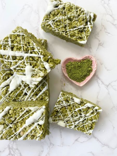 matcha rice krispie treats on a counter with some matcha powder in the shape of a heart