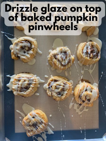maple glaze drizzled over baked pumpkin breakfast pinwheels