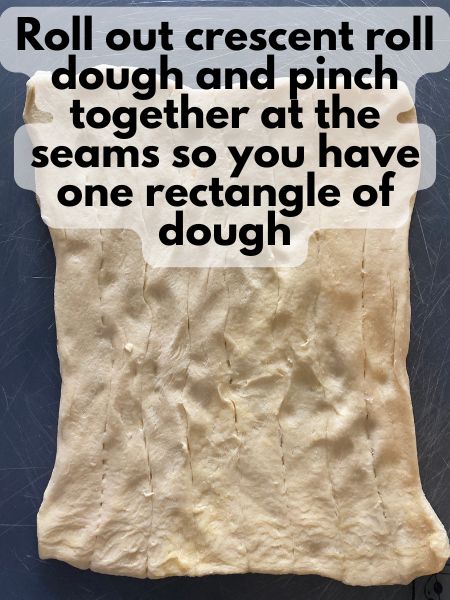 crescent roll dough in the shape of a rectangle, all of the seams have been pressed together