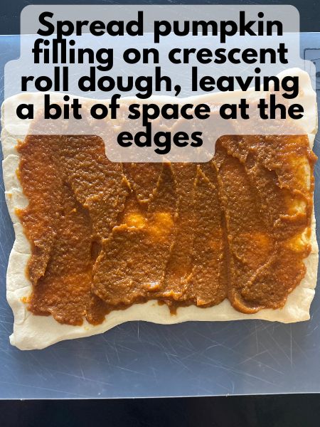 pumpkin filling spread out on top of crescent dough