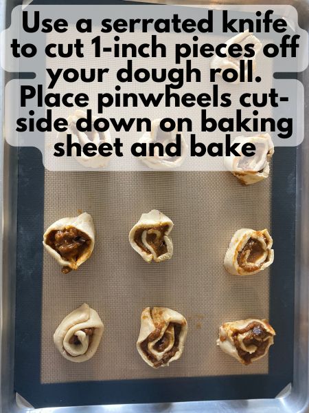 sliced pumpkin breakfast pinwheels unbaked on a baking sheet