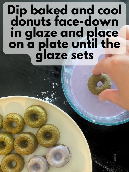 mini vegan matcha donut being dipped in lavender glaze