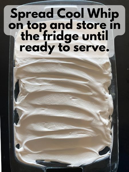 cool whip spread over the top of dulce de leche pumpkin poke cake