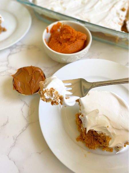 a bite of dulce de leche pumpkin poke cake on a fork