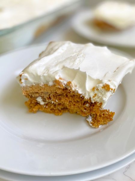 a slice of dulce de leche pumpkin poke cake