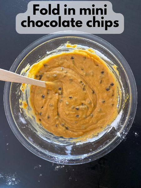 mini chocolate chips folded into pumpkin muffin batter