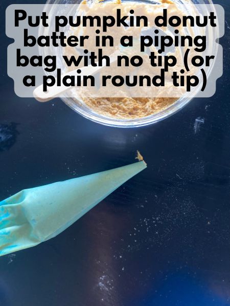 pumpkin donut batter in a piping bag