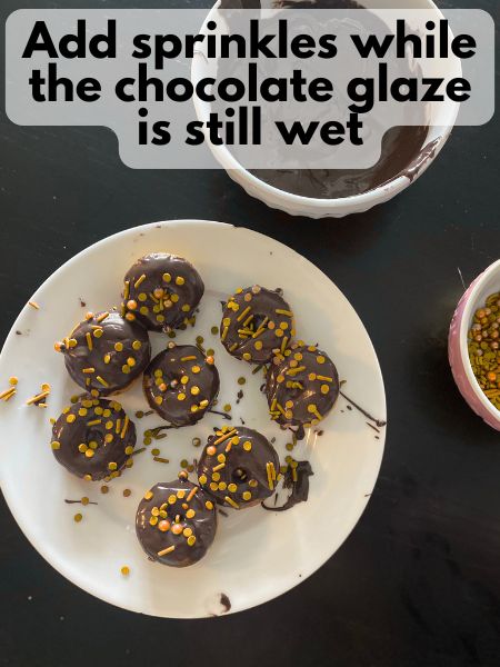 mini donuts on a plate, covered in sprinkles