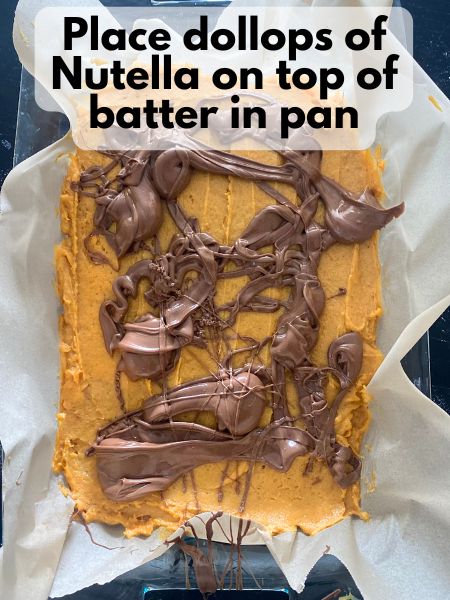 dollops of Nutella on top of pumpkin blondie batter