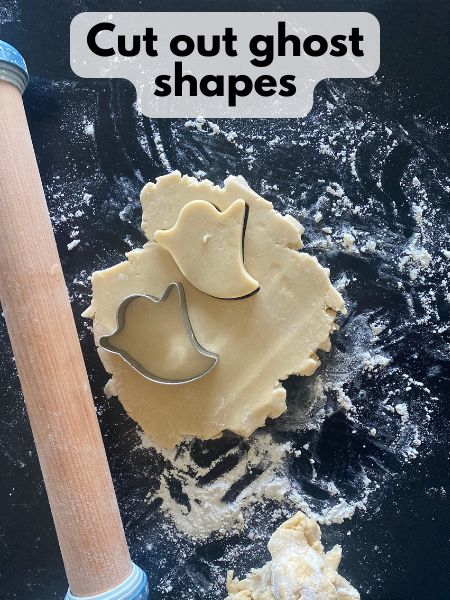 ghost shapes cut out of cutout cookie dough