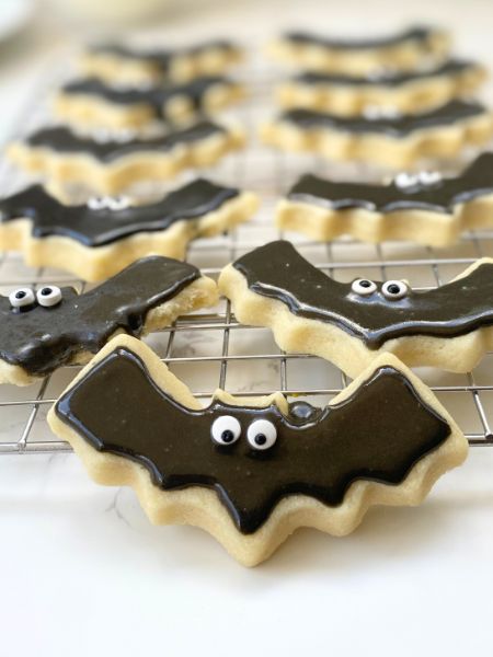 bat cutout cookies on a cooling rack