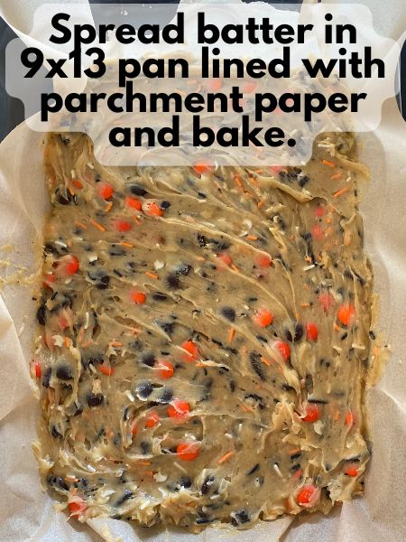 Halloween blondie batter spread in lined baking dish