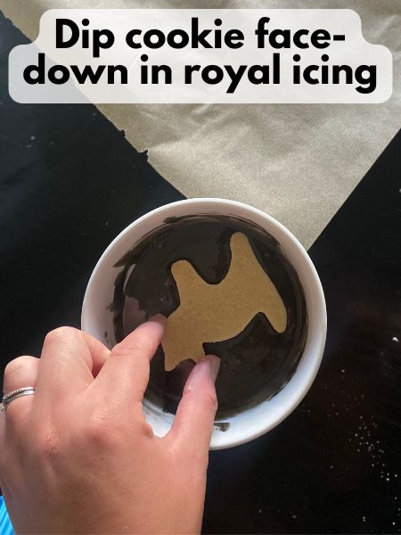 cat cookie dipped face-down in black royal icing