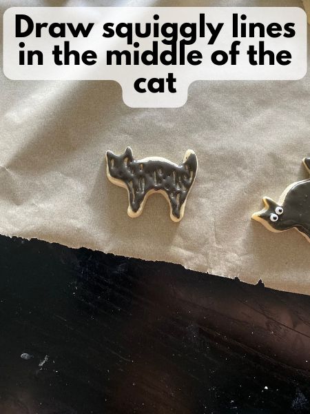 middle of cat filled in with black royal icing