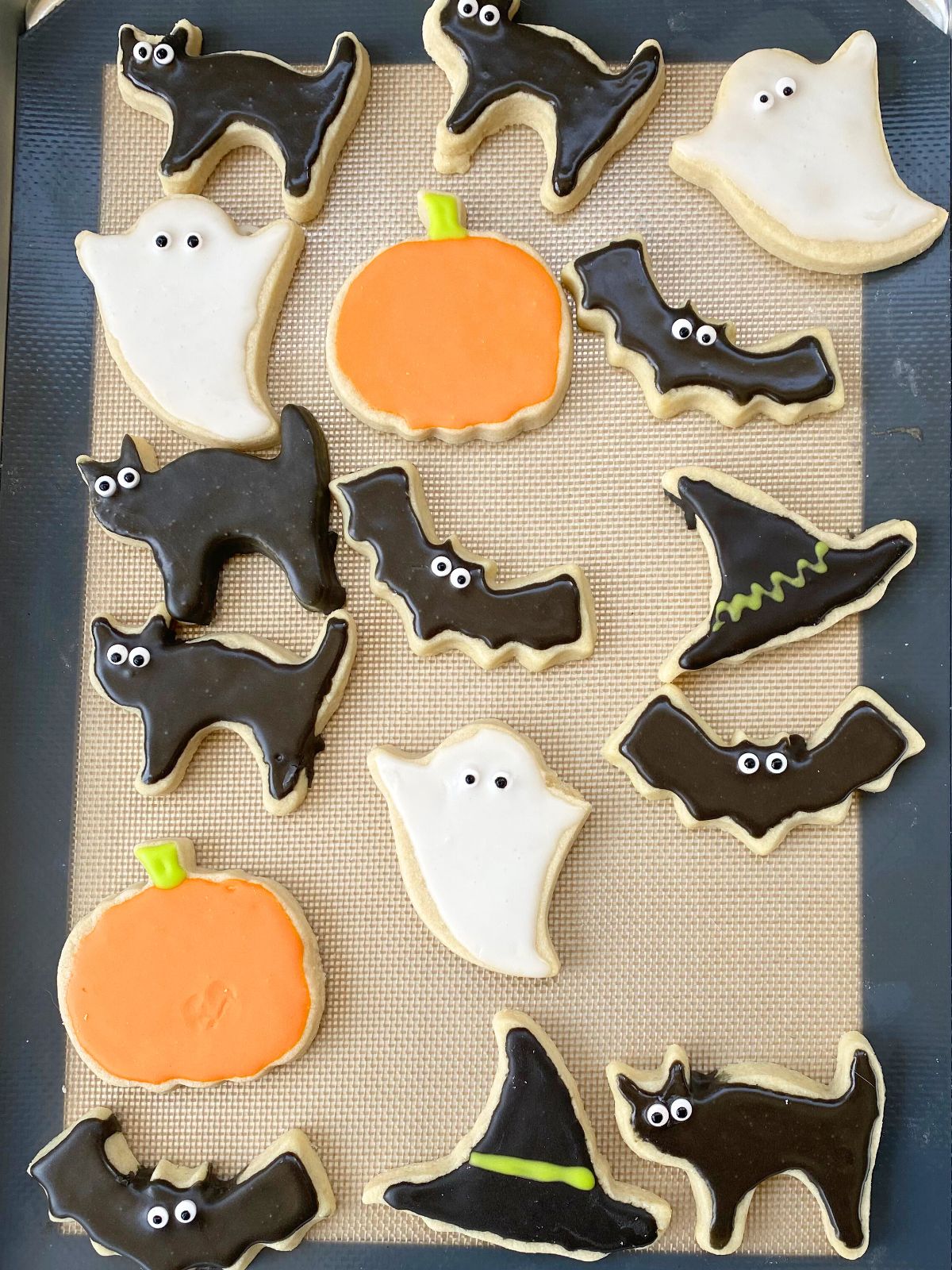 decorated halloween cookies on a baking sheet
