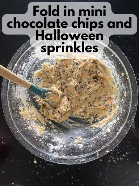 Halloween sprinkles and mini chocolate chips mixed into cookie dough