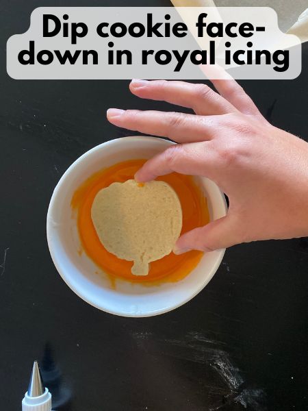 pumpkin cookie dipped face-down in royal icing
