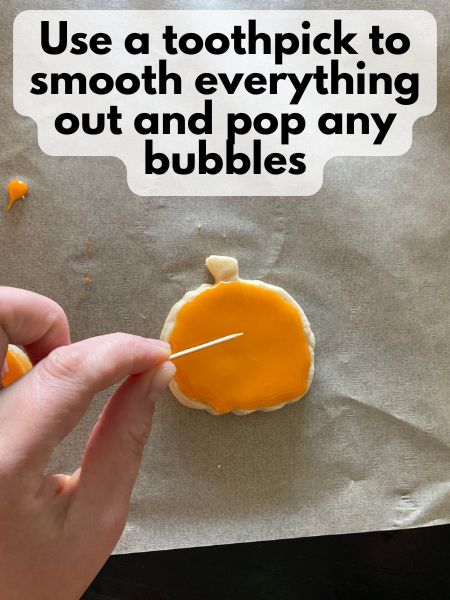 popping bubbles in icing with a toothpick