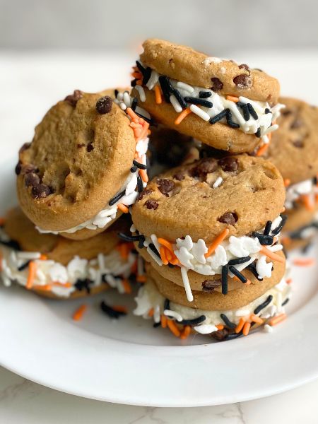 Halloween sprinkle sandwich cookies on a plate
