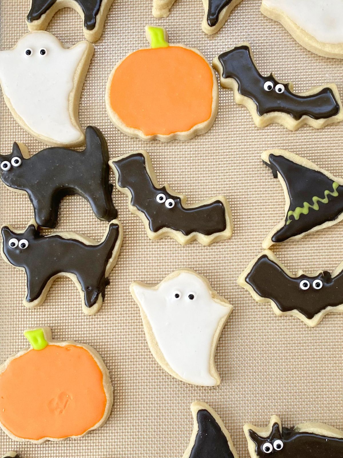 halloween decorated sugar cookies on a baking sheet