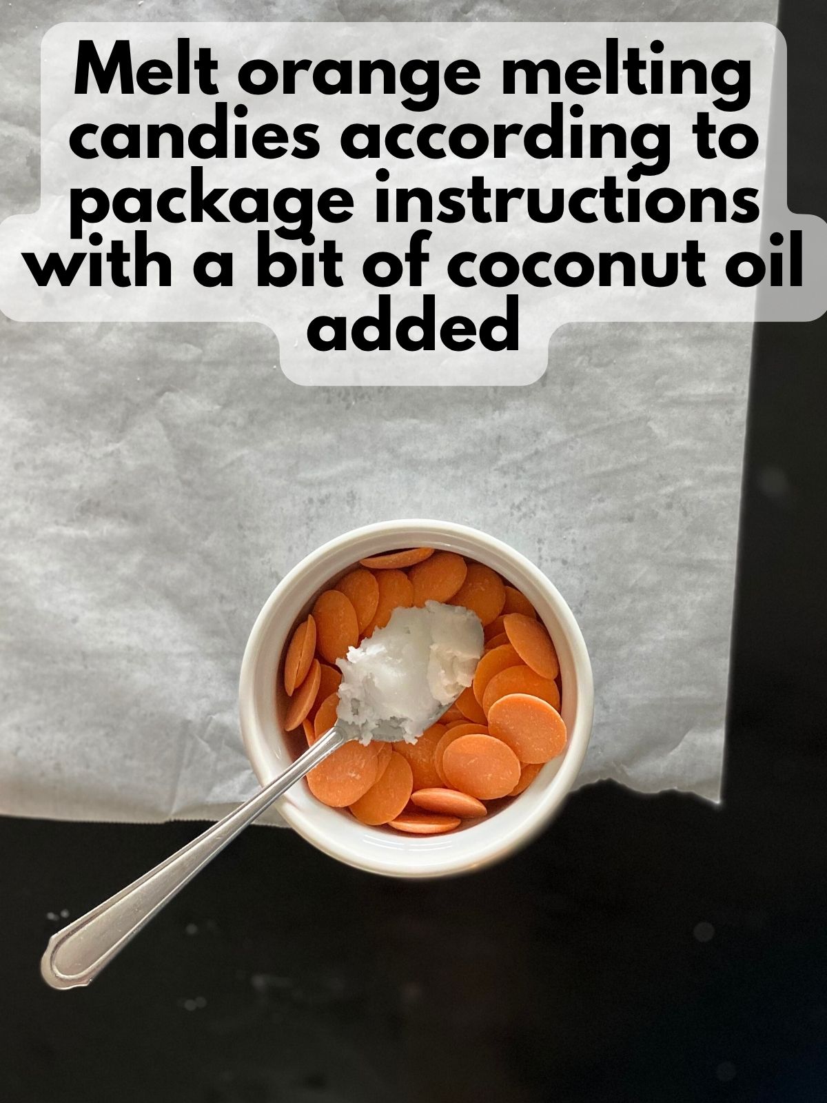 orange chocolate candy melts in a bowl with coconut oil