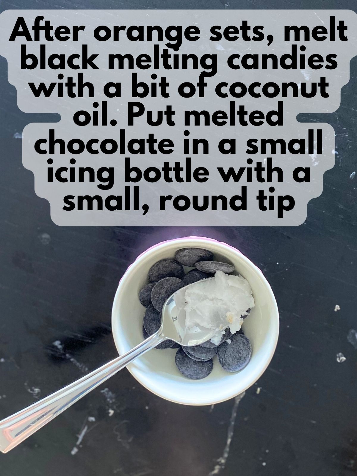 black candy melts in a bowl with coconut oil