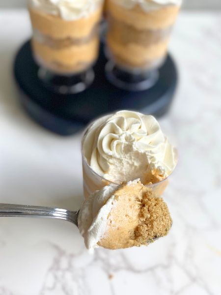 pumpkin cheesecake cups with a bite taken out of one