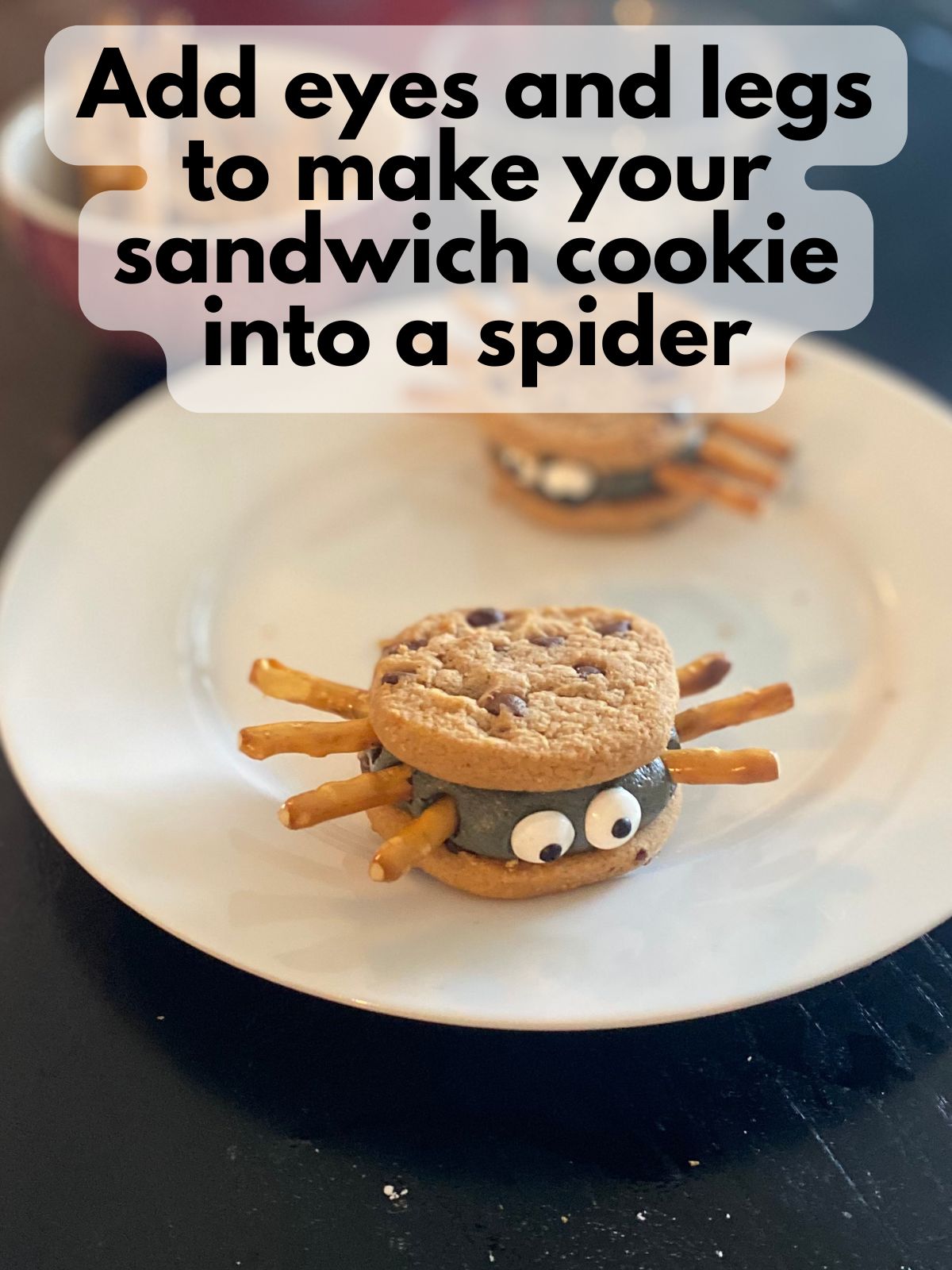 eyes and legs added to spider sandwich cookie