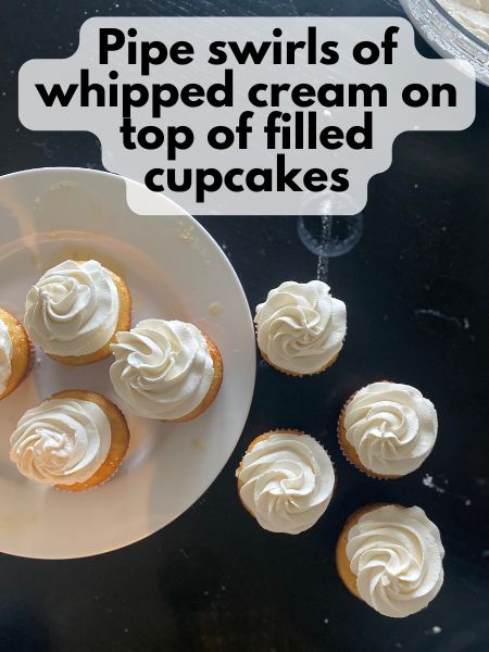 cupcakes topped with a swirl of whipped cream