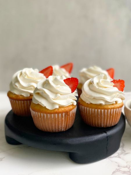 tres leches cupcakes garnished with strawberries