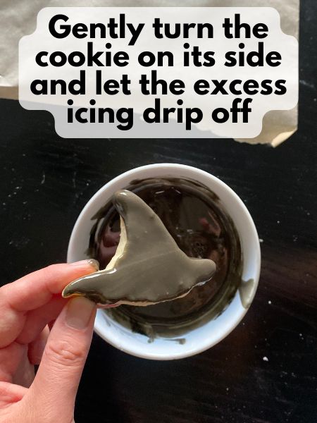 hold cookie on its side so excess icing drips off