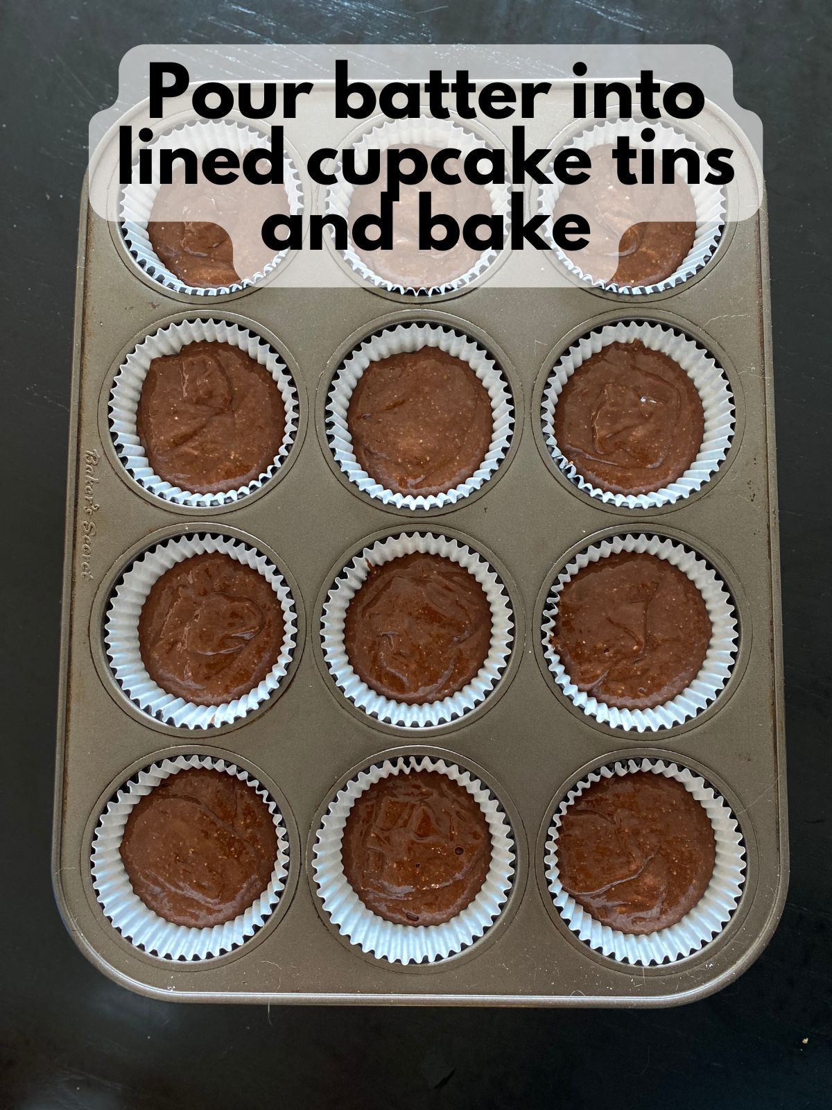 chocolate cupcake batter in lined cupcake tin