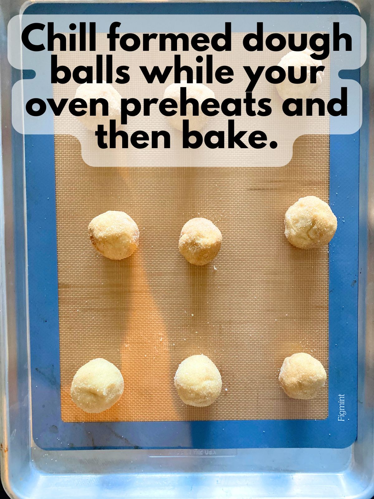 snickerdoodle dough balls on a baking sheet