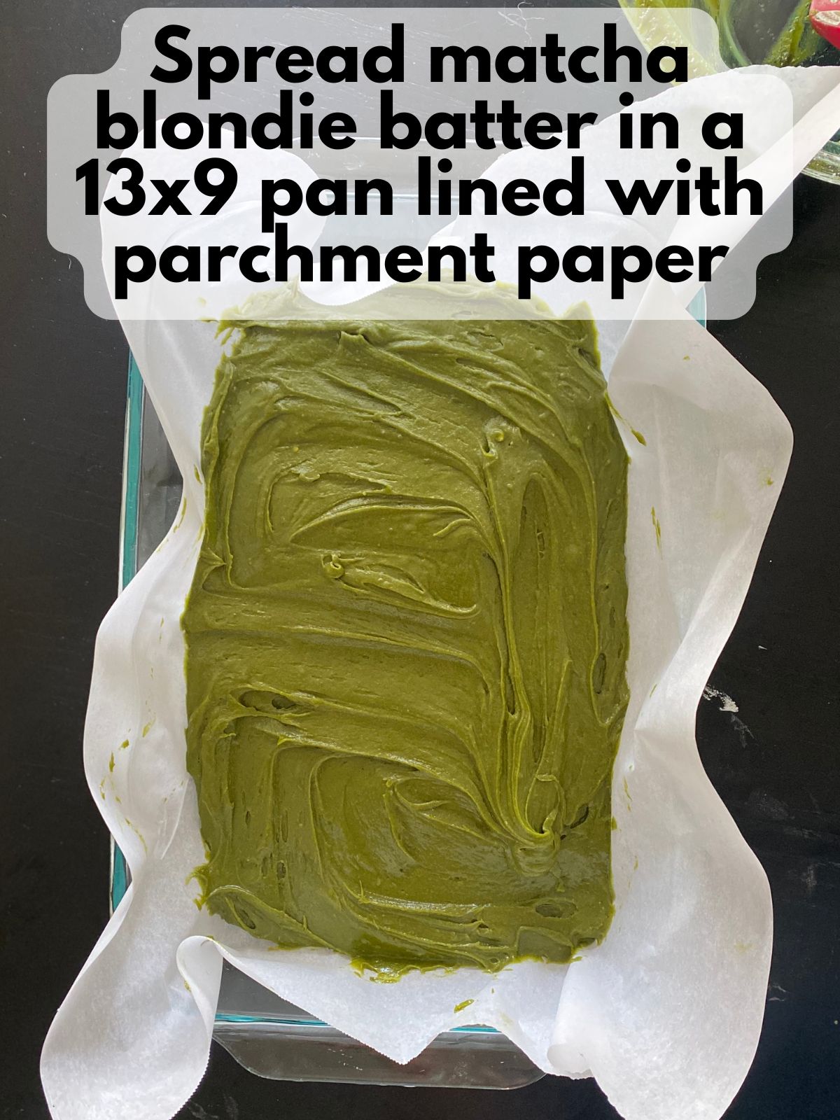 matcha blondie batter spread in a 9x13 pan