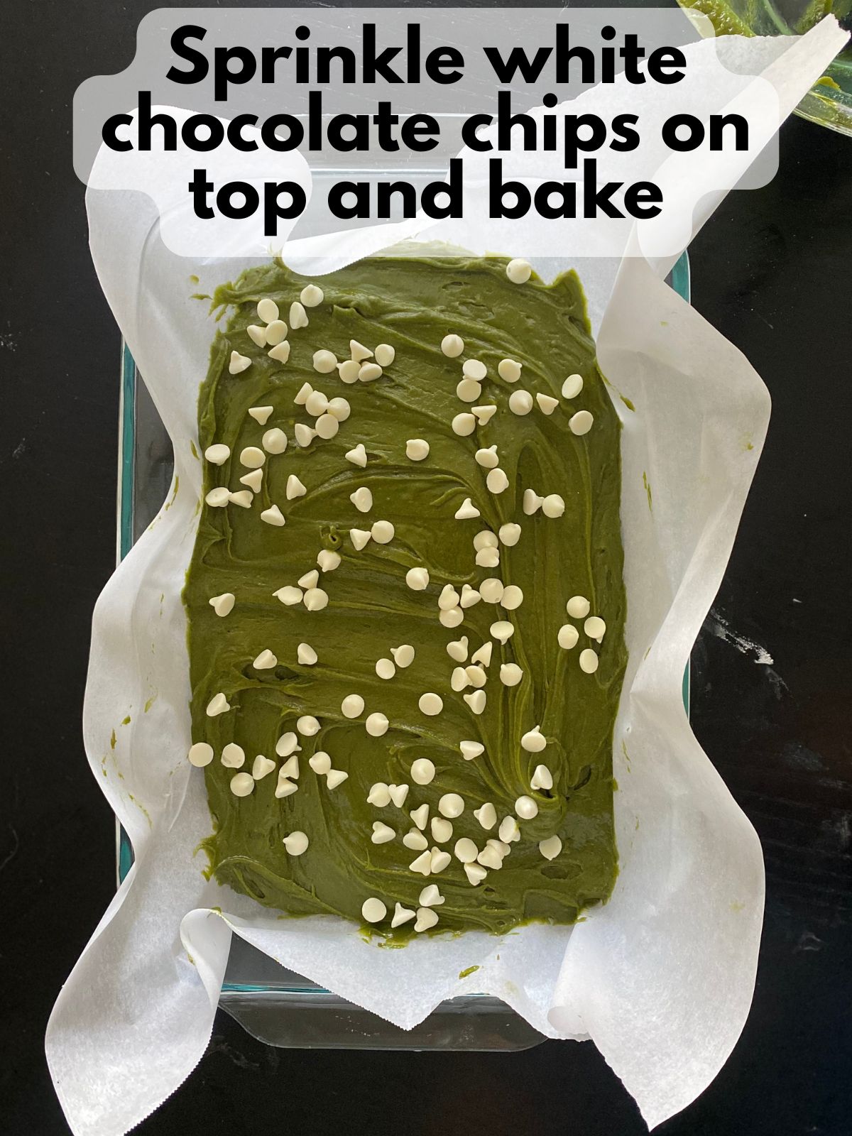 white chocolate chips sprinkled on top of matcha blondies