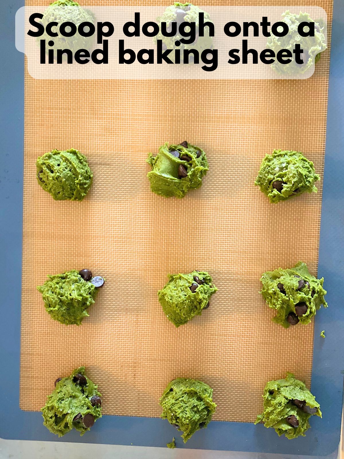matcha cake mix cookie dough scooped onto a baking sheet