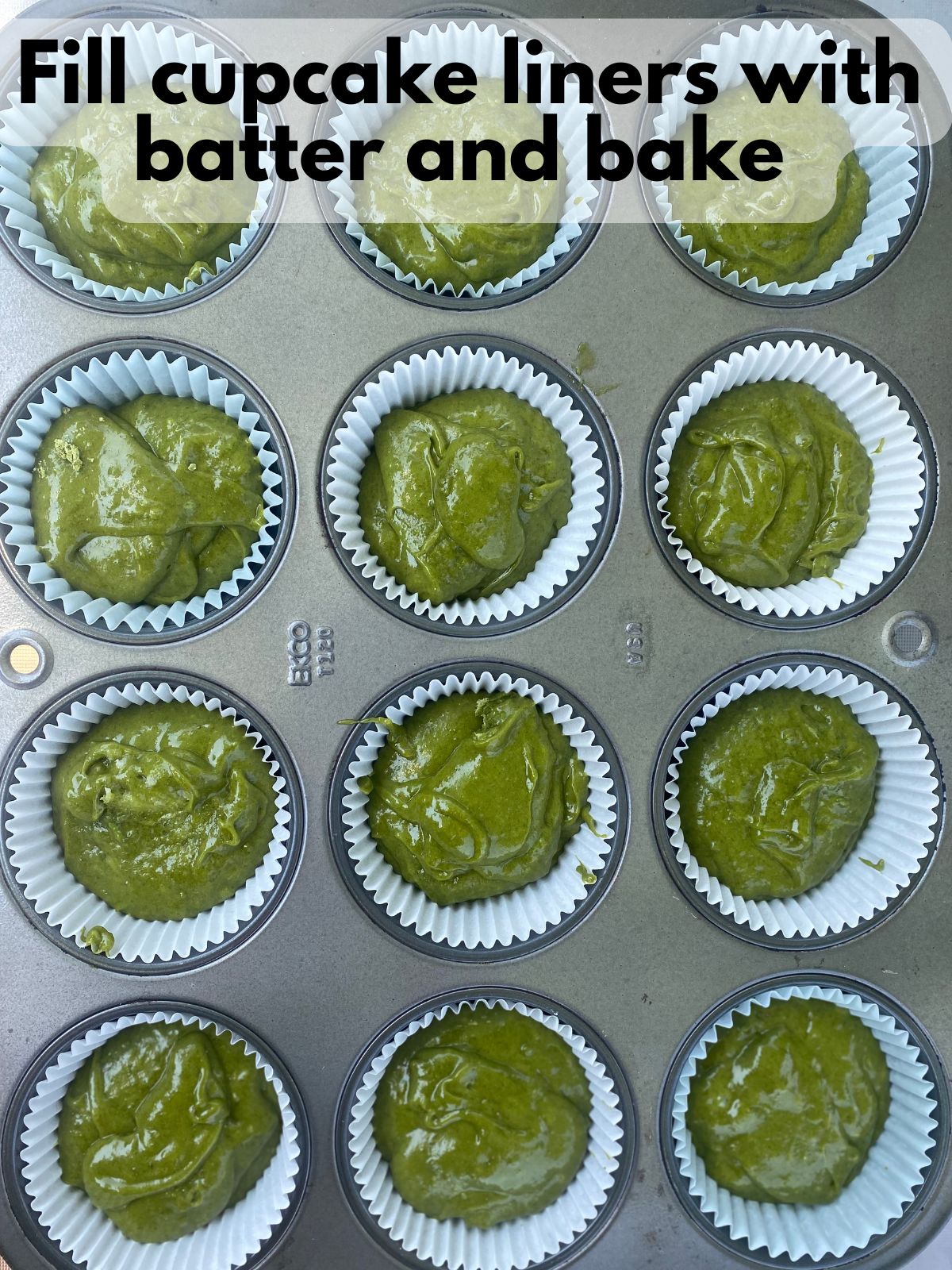 matcha cupcake batter in lined cupcake tin