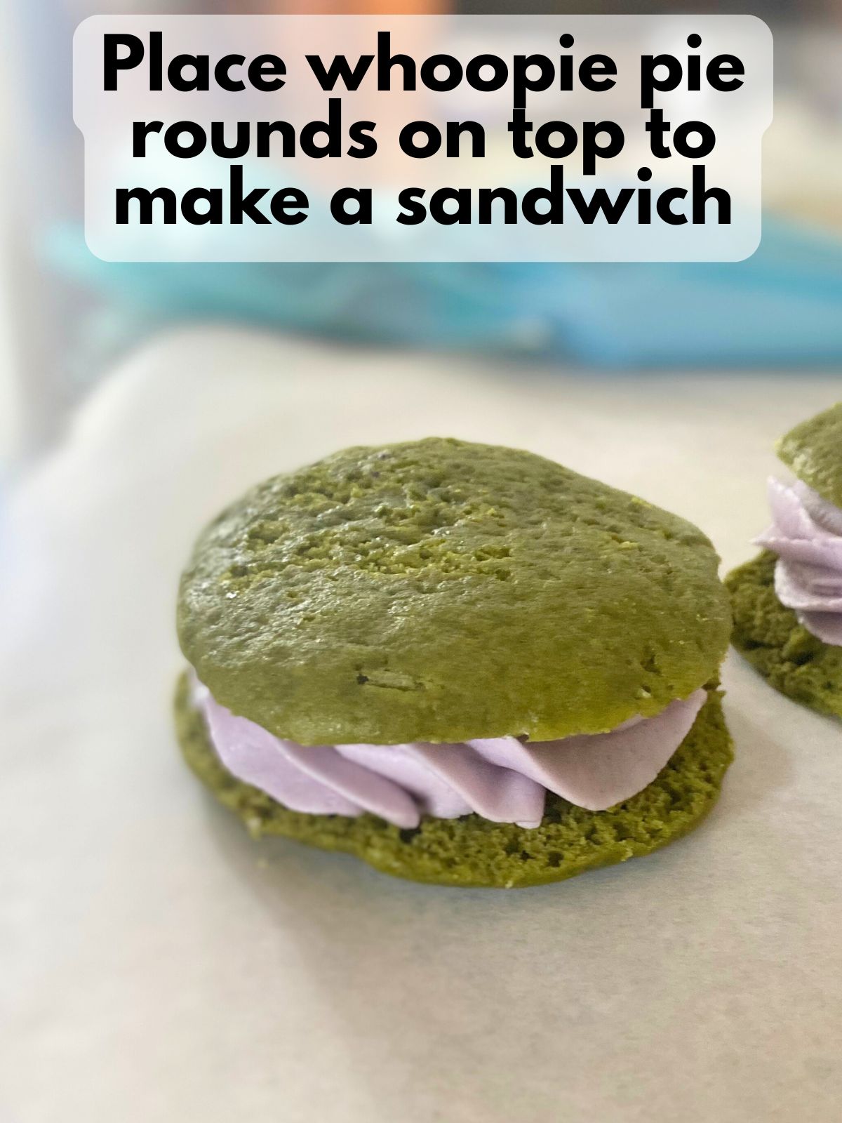 matcha whoopie pies with lavender filling on parchment paper