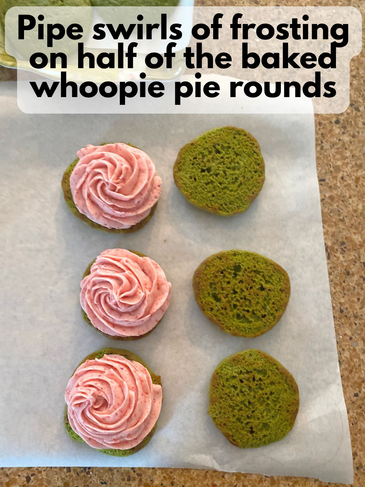 strawberry buttercream piped on half of the matcha whoopie pie rounds