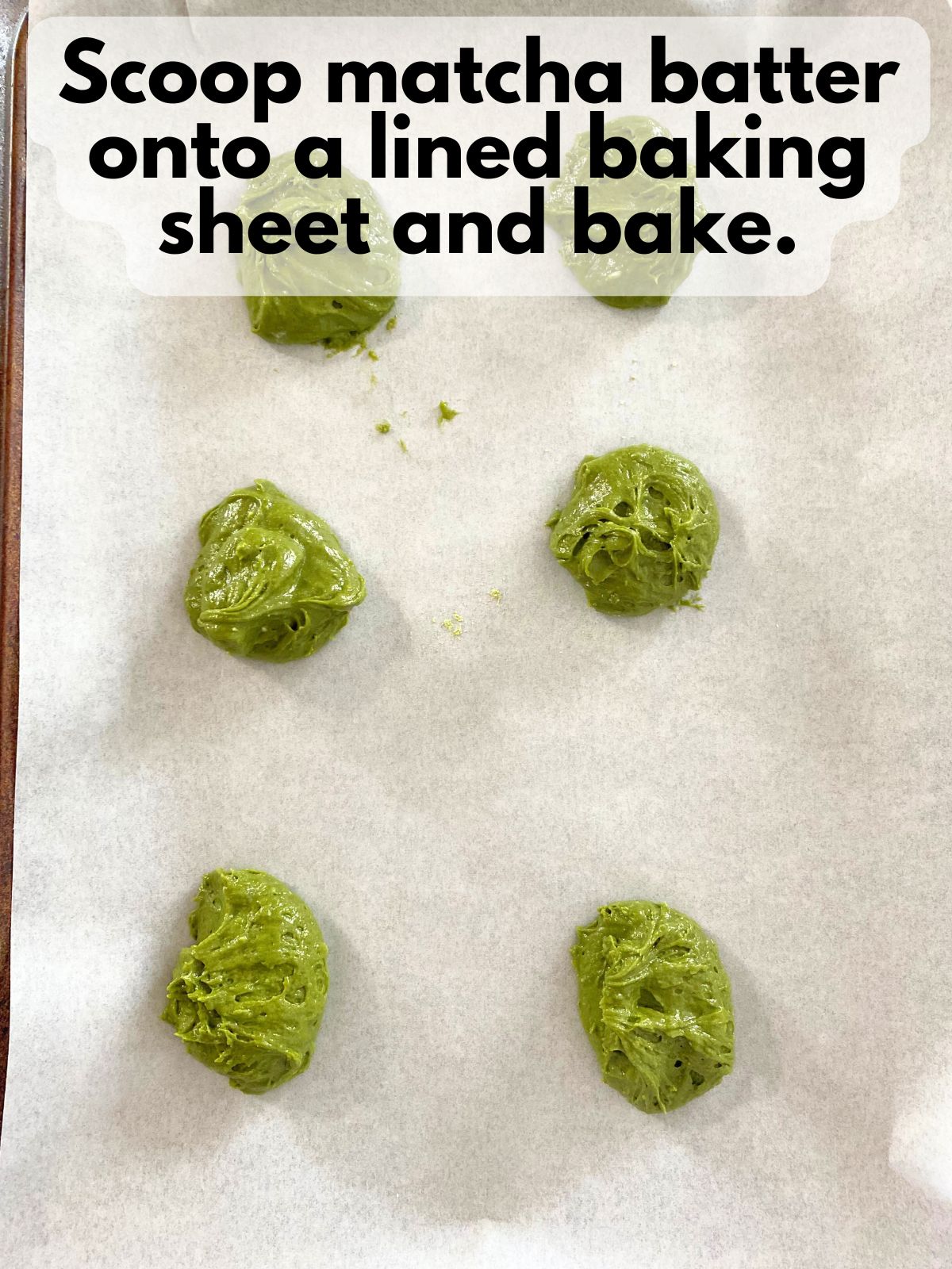 matcha whoopie pie batter on a lined baking sheet