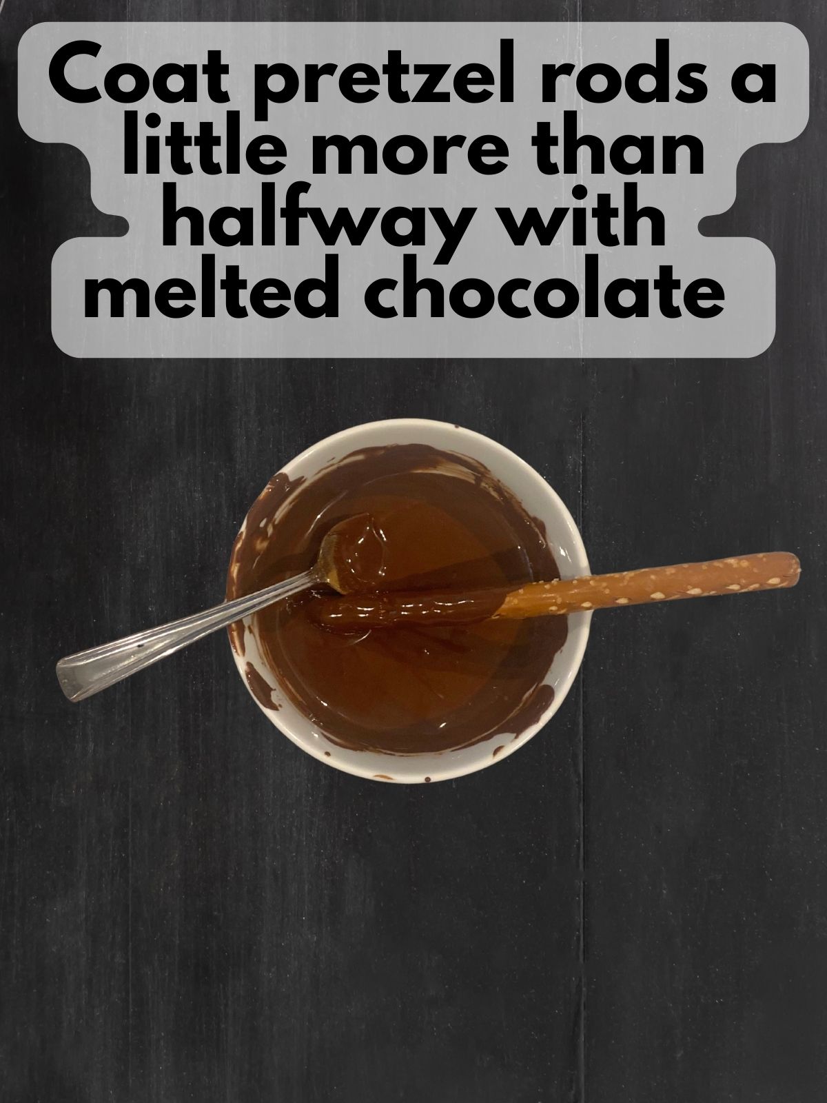 pretzel rod dipped in melted chocolate mixed with pumpkin pie spice