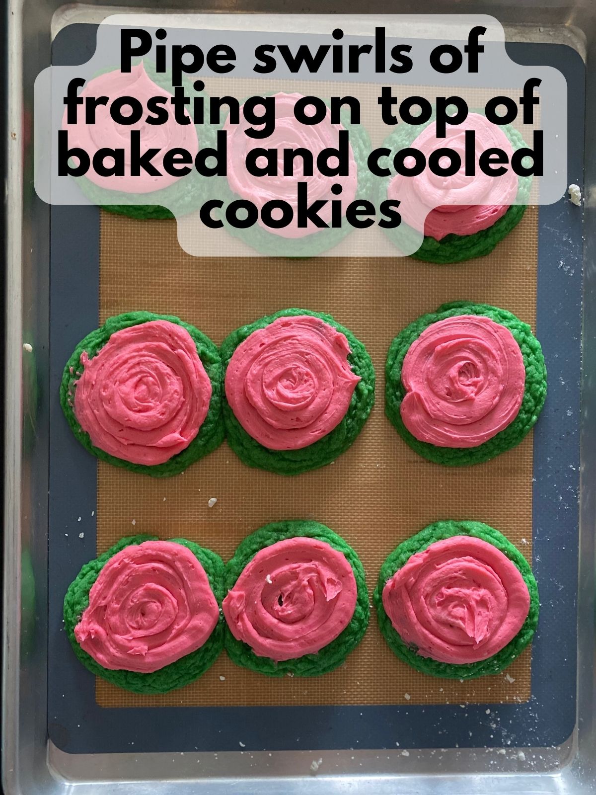 pink frosting piped onto cooled sugar cookies