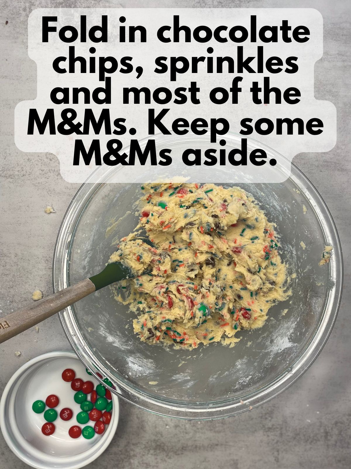 M&Ms and sprinkles folded into cookie dough