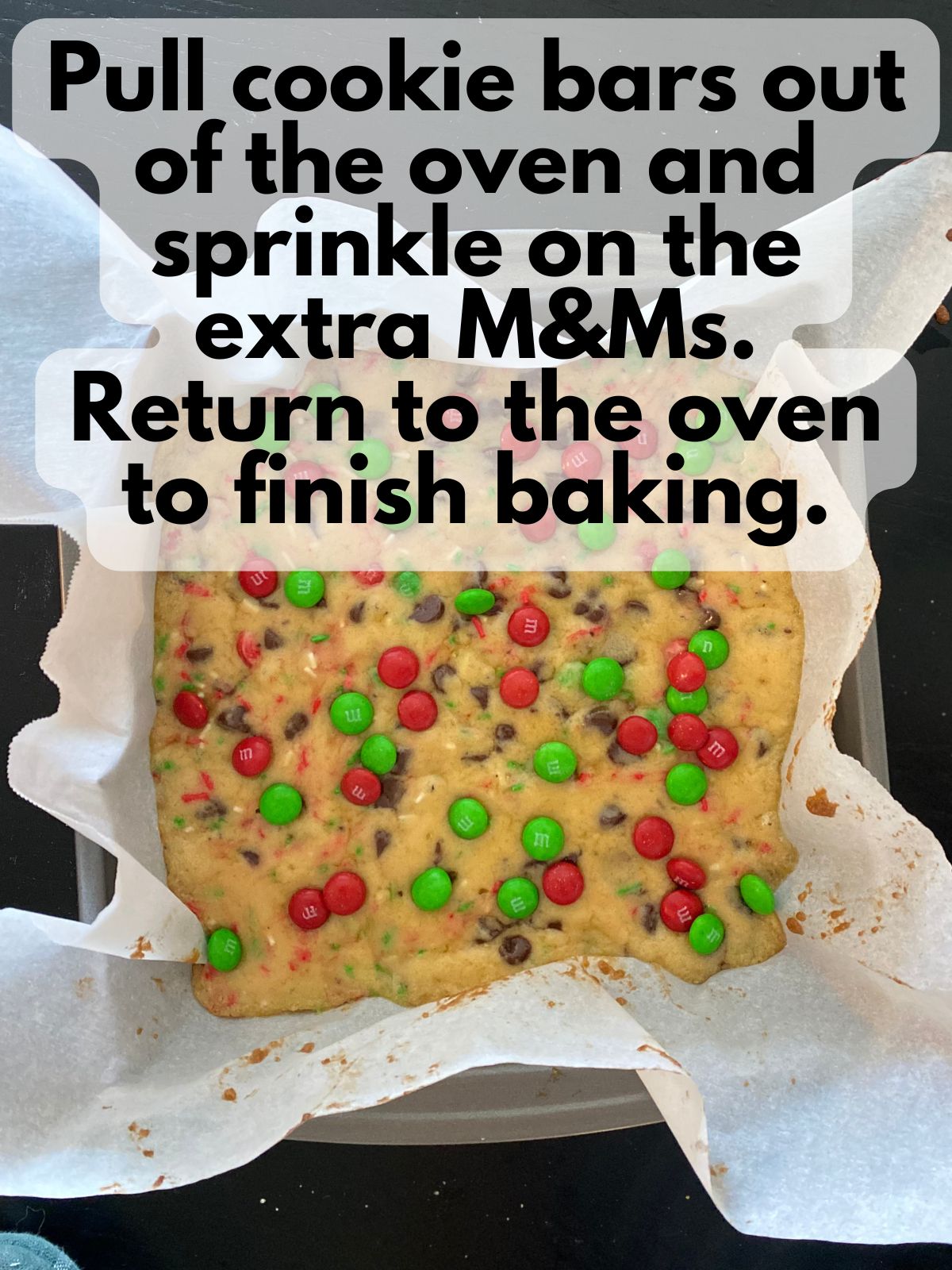 extra M&Ms sprinkled on top of parbaked cookie bars