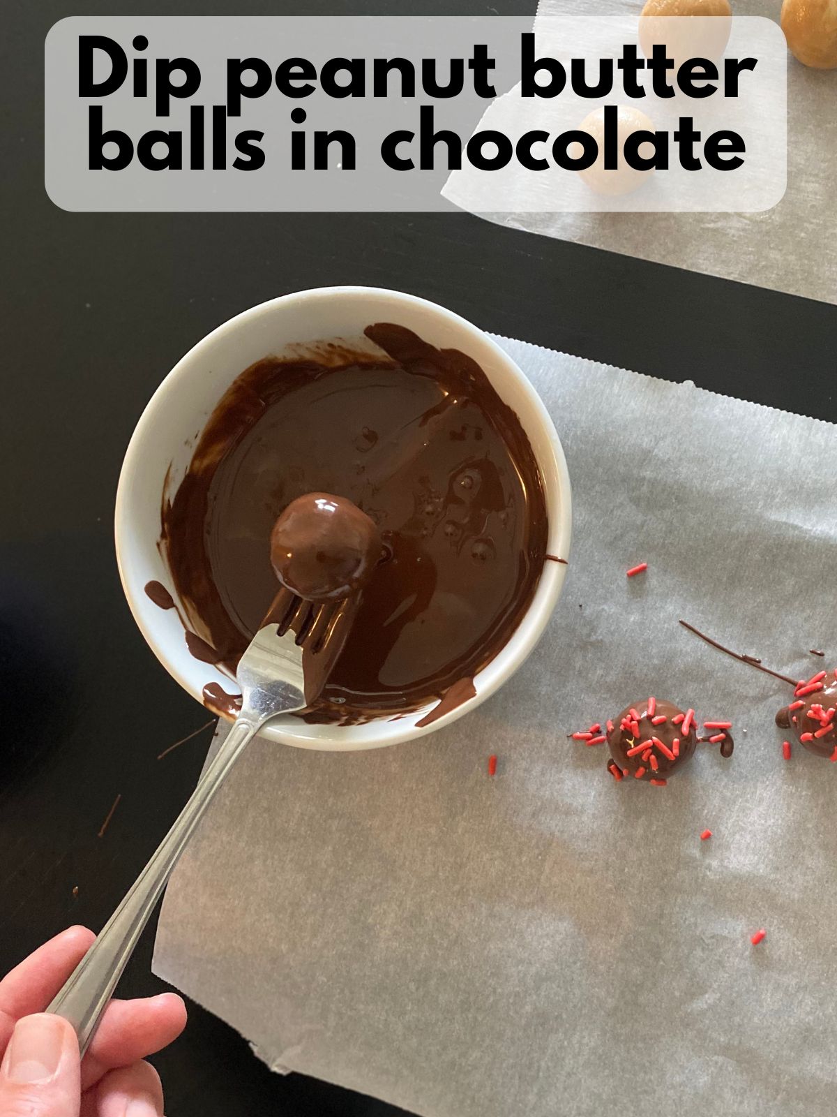 peanut butter ball dipped in chocolate and decorated with sprinkles