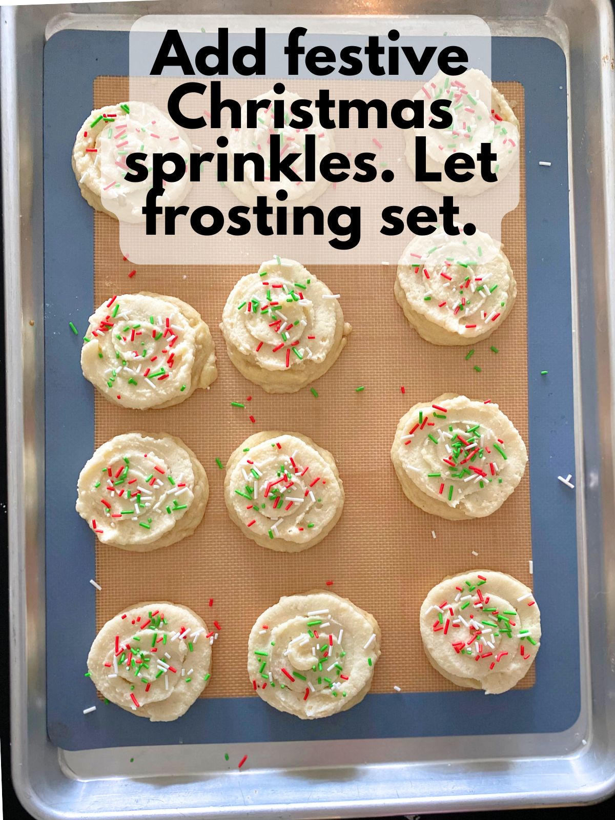 frosted sugar cookies decorated with Christmas sprinkles
